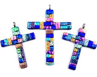 May include: Three colorful glass crosses with a mosaic design in shades of blue, pink, yellow, and green.
