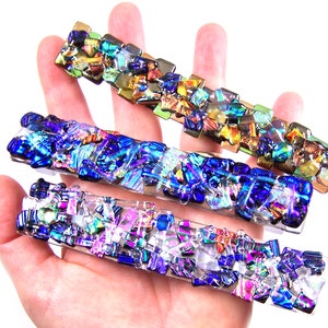 May include: Three rectangular glass pieces with iridescent mosaic designs in shades of blue, green, gold, and purple.
