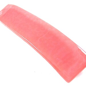 May include: A long, thin, translucent pink hair clip.