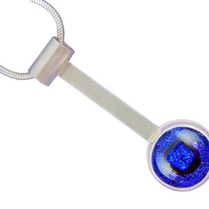 May include: Silver-toned pendant necklace featuring a geometric design. The pendant has a rectangular bar connected to a circular element with a vibrant blue, square-shaped center. The necklace chain is a thin, silver snake chain.