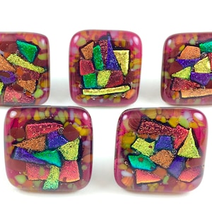 May include: Five square-shaped glass tiles with a red base and colorful geometric patterns. The patterns are made of iridescent glass pieces in shades of green, yellow, purple, and gold.