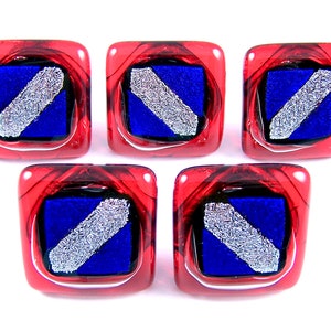 May include: Five square glass buttons. Each button has a red border with a blue square center. A diagonal silver stripe is across the blue square. The buttons are arranged in a 2x3 formation, with one button missing from the top row.