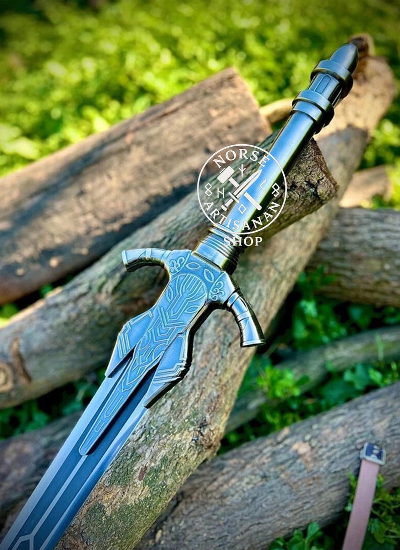 May include: A detailed, blue-grey sword with intricate designs on the hilt and blade, resting on wooden logs. The sword features a crossguard and a pointed tip. The image includes the text "NORS ARTISAN SHOP" in a circular logo.