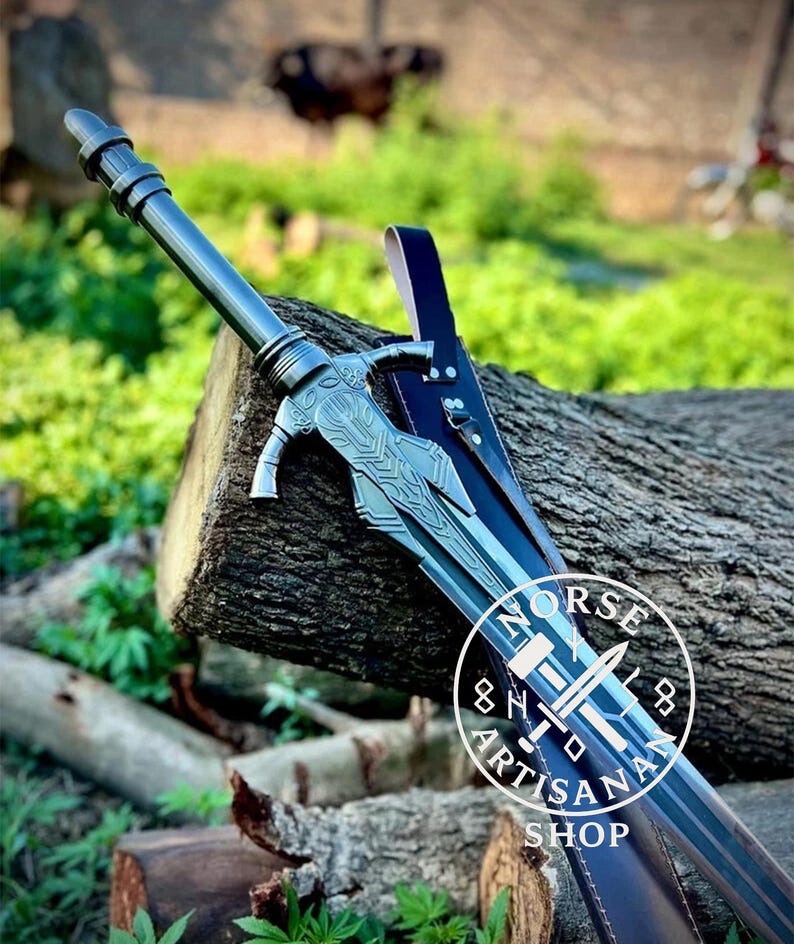May include: A detailed image of a silver sword with intricate designs, resting on a wooden log. The sword has a decorative hilt and a long, sharp blade. A black leather sheath is visible. The image includes a circular logo with the text "NORSE ARTISAN SHOP".