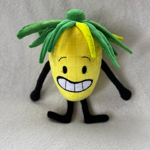 May include: A plush pineapple toy with a smiling face, black arms and legs, and green and yellow leaves. The yellow body has a grid pattern. The toy is designed to look like a cartoon character.