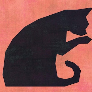 May include: A black geometric cat silhouette on a textured peach background. The cat is depicted in a seated position, with its tail curled and one paw raised towards its face. The artwork has a minimalist, modern aesthetic.