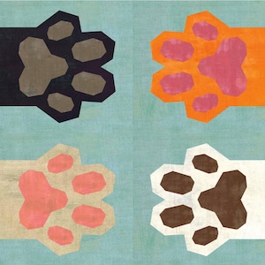 May include: An artistic print showcasing four cat paws in a square. The paws are black, orange, beige, and white, with pink and brown pads. The background is a textured light blue. A playful and colourful design.