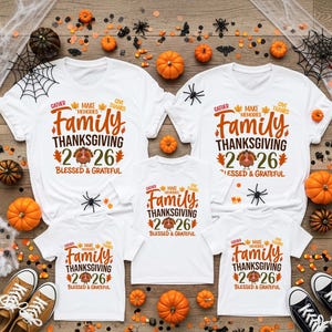 May include: Five white t-shirts featuring a Thanksgiving graphic with the text Gather, Make Memories, Give Thanks, Family, Thanksgiving, 2026, and Blessed & Grateful, accompanied by illustrations of a turkey and autumn leaves.