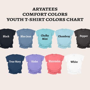 May include: ARYATEES COMFORT COLORS YOUTH T-SHIRT COLORS CHART displaying nine short-sleeve shirts in black, blue jean, chalky mint, chambray, pepper, true navy, violet, watermelon, and white, each labeled with its respective color name.