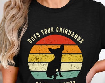 May include: Black t-shirt featuring a retro design with a silhouette of a Chihuahua inside a sunset circle. The text reads "DOES YOUR CHIHUAHUA DO TRICKS TOO?" in white, perfect for dog lovers.