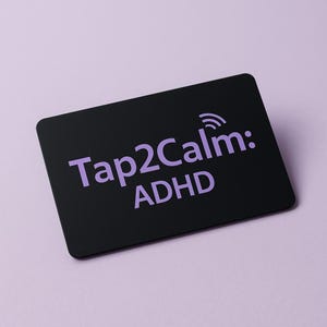 May include: A black rectangular card with rounded corners. The card features the text "Tap2Calm: ADHD" in a light purple color, along with a small wireless signal icon. The background is a solid light purple.