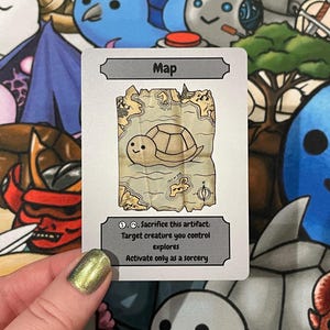May include: A white card with the word "Map" at the top. The card features a cartoon map with a turtle illustration. The text below reads "Sacrifice this artifact: Target creature you control explores. Activate only as a sorcery."