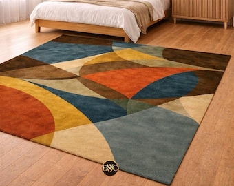 May include: A rectangular area rug featuring a large-scale geometric pattern with overlapping circular and curved shapes. The design incorporates a palette of deep blue, burnt orange, mustard yellow, brown, and beige tones across the surface.