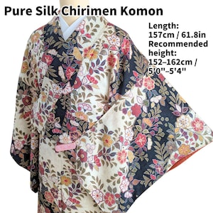 May include: A patterned kimono with the text "Pure Silk Chirimen Komon". The garment features a floral design in red, cream, black, and gold. The length is 61.8 inches, and the recommended height is between 5'0"-5'4".