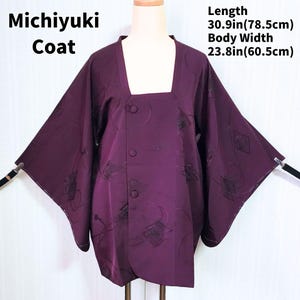 May include: A deep purple Michiyuki coat with a square neckline and three buttons. The coat features a subtle pattern and measures 30.9 inches (78.5 cm) in length and 23.8 inches (60.5 cm) in body width. The text "Michiyuki Coat" is displayed on the upper left.