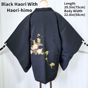 May include: Black haori with haori-himo. The black jacket has a floral design on the back with yellow and white flowers. The length is 29.5 inches (75cm), and the body width is 22.8 inches (58cm).