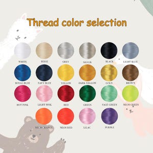 May include: A color chart displaying thread color options. The text "Thread color selection" is at the top. Colors include white, beige, grey, silver, black, light blue, royal blue, navy blue, yellow, dark yellow, gold, brown, hot pink, light pink, red, green, sage green, neon green, neon orange, neon red, lilac, and purple.