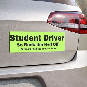 May include: A green and black student driver car magnet with the text "Student Driver So Back the Hell Off! Or You'll Face the Wrath of Mom!"