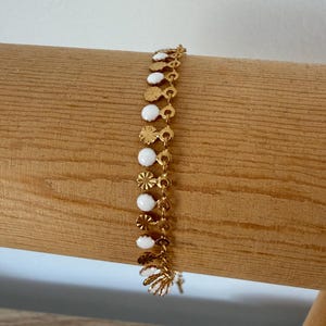 Gold and white stainless steel charm bracelet