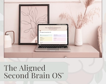 May include: A laptop displaying a Notion template titled "The Aligned Second Brain OS" sits on a light-colored desk. A framed botanical print and a vase with dried flowers are in the background. The text "The Aligned Second Brain OS" is at the bottom.