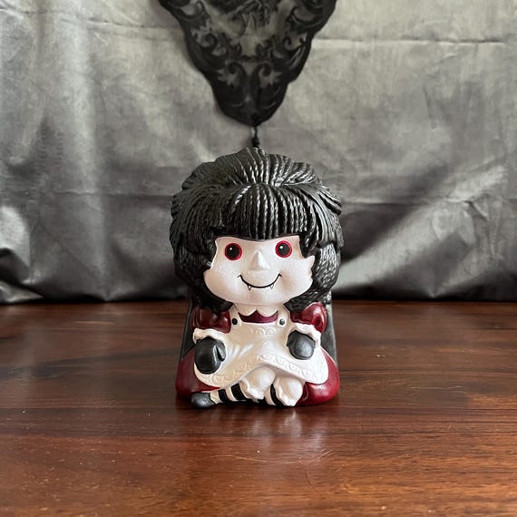 A one-of-one Raggedy Ann doll transformed into a gothic vampire planter — outsider folk art energy that's genuinely unsettling in the best possible way.
