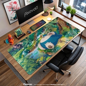 May include: A large desk mat featuring a cartoon Snorlax character in a forest setting. The mat is rectangular, with dimensions of 23.6" x 47.2". The mat has a colorful design with the word "Pixavaa" on the bottom. A computer, keyboard, and mouse are on the desk.
