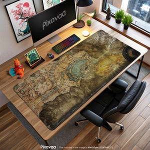May include: A large rectangular desk mat featuring a detailed map design in shades of brown, beige, and blue. The mat, measuring 23.6" x 47.2", is placed on a wooden desk with a computer, keyboard, and mouse. The Pixavaa logo is visible.