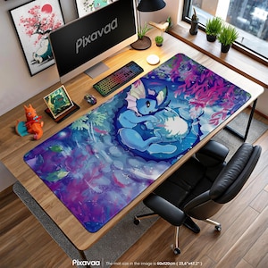May include: A large rectangular desk mat featuring a blue and white illustration of a Vaporeon character. The mat is 23.6" x 47.2" and has a colorful design with aquatic elements. The word "Pixavaa" is printed on the mat.