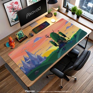 May include: A rectangular desk mat with a cartoon landscape design, including mountains, trees, and a sunset. The mat measures 60cm x 120cm and is placed on a wooden desk with a computer, keyboard, and mouse.