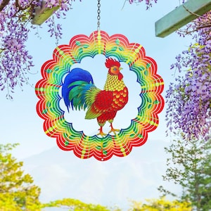 May include: A circular metal wind spinner featuring a vibrant, multi-colored scalloped border in shades of red, orange, yellow, green, and blue. The center displays a detailed illustration of a rooster with a red comb, yellow neck, and blue tail.