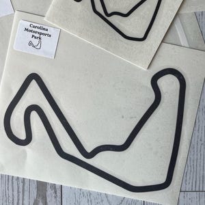 May include: A set of three ceramic nesting bowls in shades of blue, green, and white. The bowls feature a speckled glaze and a simple, modern design. The largest bowl measures approximately 6 inches in diameter.