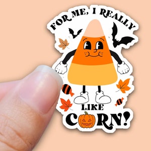 May include: A cartoon candy corn with a smiling face and the text "For me, I really like corn!"  The candy corn is wearing shoes and has a pumpkin face below the text.