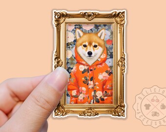 May include: A sticker of a Shiba Inu dog wearing a floral patterned orange jacket, framed in a gold ornate frame. The dog is looking directly at the viewer.
