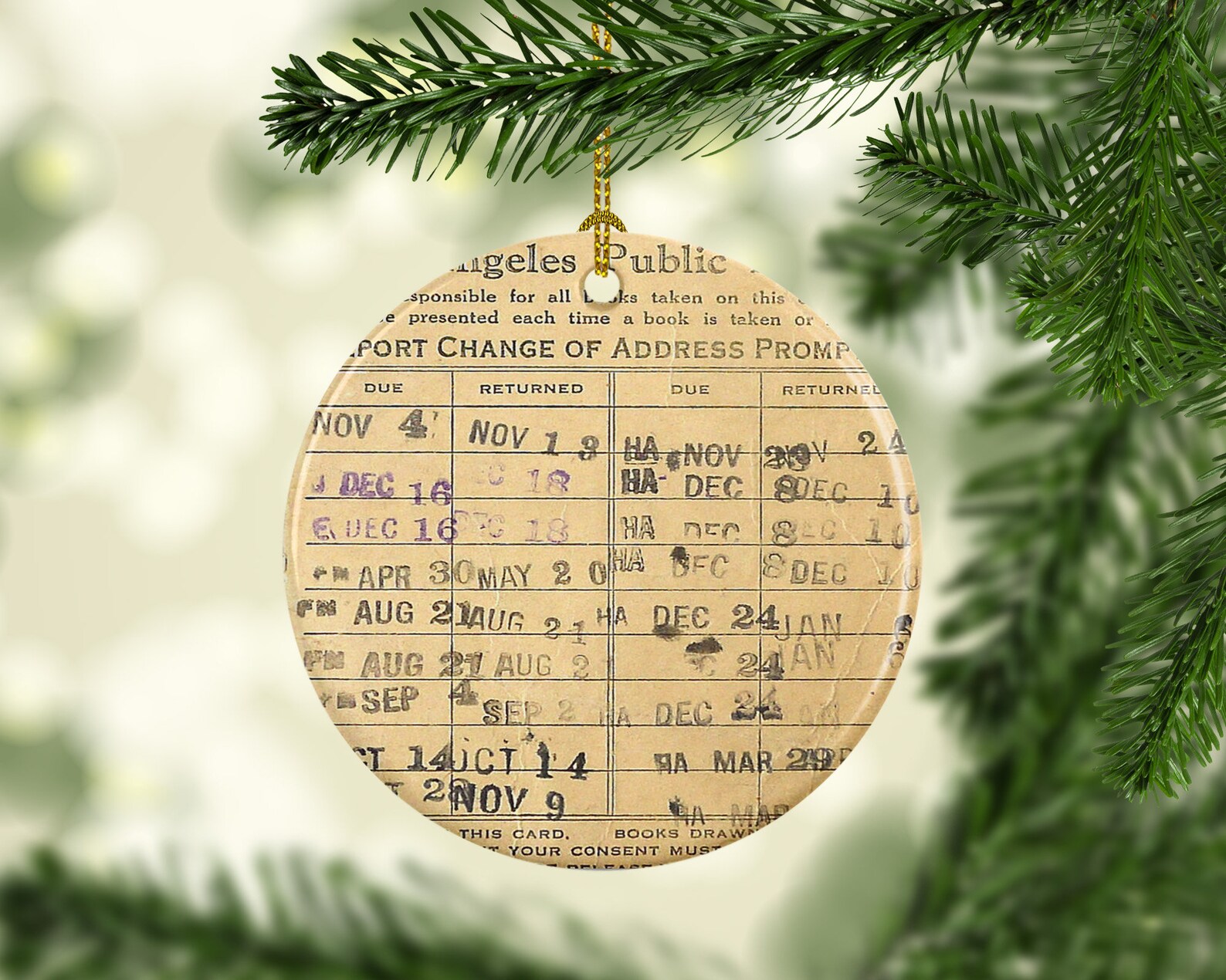 a tree ornament made to look like a vintage library check out card with different due dates
