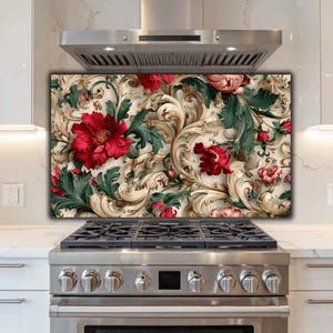 May include: A decorative kitchen backsplash with a detailed floral design. The design features large red flowers, green leaves, and ornate cream scrollwork. The backsplash is installed above a stainless steel gas hob.