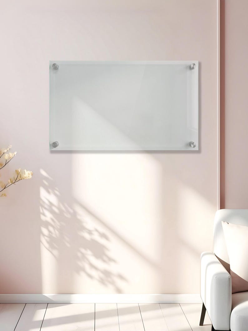 May include: A rectangular clear acrylic dry erase board mounted to the wall with four silver-toned metal standoffs at each corner. The board features a smooth, transparent surface designed for writing and is positioned horizontally on the wall.