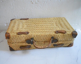 vintage straw and leather suitcase