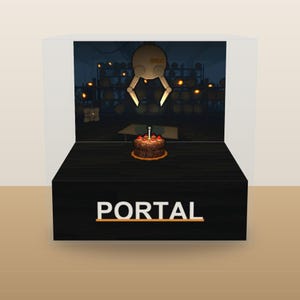 May include: A display case featuring a chocolate cake with red cherries on top, positioned beneath a mechanical claw. The base of the display is black with the word PORTAL printed in white letters with an orange line underneath the text.