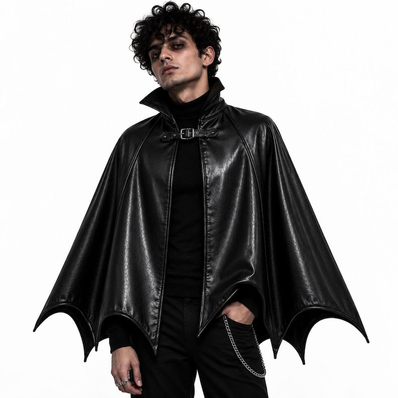 Man wearing black gothic vampire batwing cape with high collar, front buckle and dramatic Halloween cosplay look