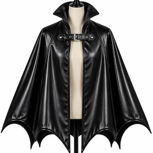 Black gothic vampire batwing cape on mannequin, long leather cloak with high collar and front buckle closure