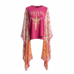 May include: A bright pink t-shirt featuring the text NIRVANA LIVE '93 and a gold winged figure graphic. The shirt has long, flowing, sheer sleeves in white and orange with a floral pattern and small pink pom-pom trim along the bottom edges.