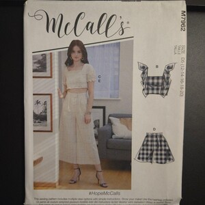 May include: A McCall's sewing pattern package featuring a woman wearing a matching crop top and pants set. The package includes illustrations of the outfit and the text "#HopeMcCalls". The pattern size is D5 (12-14-16-18-20).