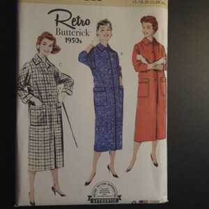 May include: A vintage Butterick sewing pattern from the 1950s, featuring illustrations of three long coats. The pattern includes sizes 18-26. The cover has the words "Retro Butterick 1950s" and "Authentic".
