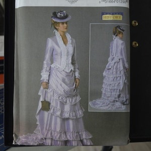 May include: A Butterick sewing pattern featuring a historical costume design. The illustration shows a woman in a lavender dress with ruffles and a matching hat. The pattern includes the text "B6692" and "HISTORY".