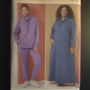 May include: A Butterick sewing pattern, B7014, featuring two women modeling loungewear. One woman wears a purple sweatsuit, the other a blue dress. The pattern includes sizes BB (1X-5X).