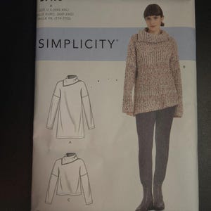 May include: A Simplicity sewing pattern package featuring a woman wearing a cowl-neck sweater and leggings. The package includes illustrations of the sweater design and the text "SIMPLICITY" and "S9178". The size range is XXS-XXL.