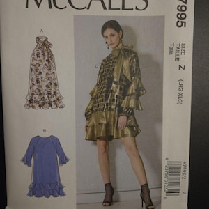May include: McCall's sewing pattern M7995. The pattern features a woman wearing a gold and black patterned dress with ruffles. The pattern also shows a skirt with a floral pattern and a blue dress with ruffles. Size Z (LRG-XLG).