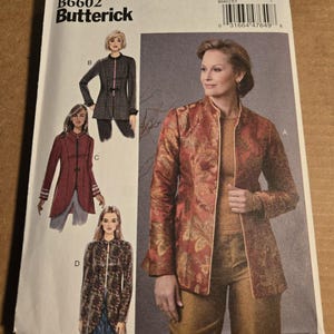 May include: A Butterick B6602 sewing pattern envelope featuring illustrations and a photograph of a long-sleeved jacket with a mandarin collar. The pattern includes size range E5 (14-16-18-20-22) and displays four variations of the jacket design.