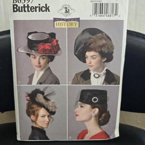May include: A Butterick B6397 sewing pattern envelope featuring four distinct hat designs labeled A, B, C, and D. The cover displays photographs of individuals wearing these hats, which include floral, feathered, and netted embellishments.