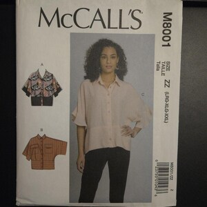 May include: McCall's sewing pattern M8001, featuring a woman wearing a light pink button-down shirt and black pants. The pattern includes illustrations of two shirt designs. The size is ZZ (LRG-XLG-XXL).